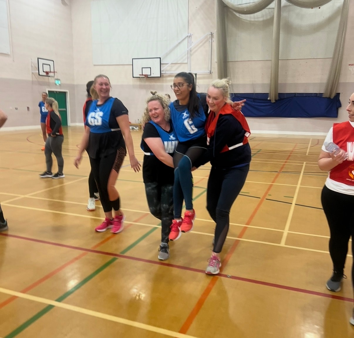 Women running together in gymnasium