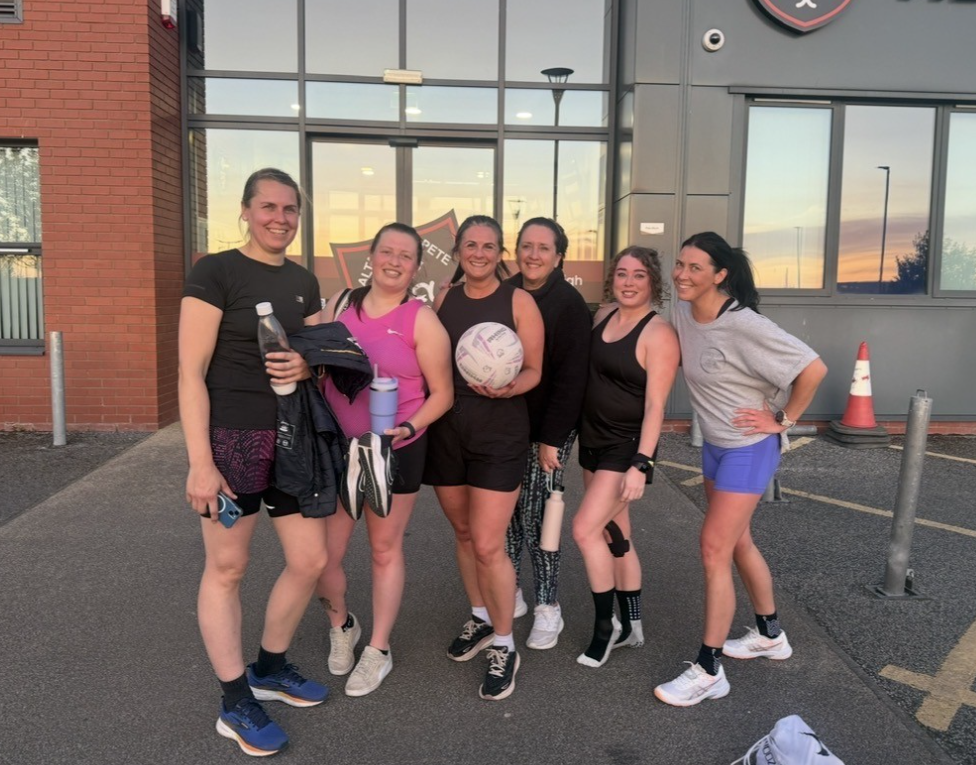 Group of women posing with sports equipment