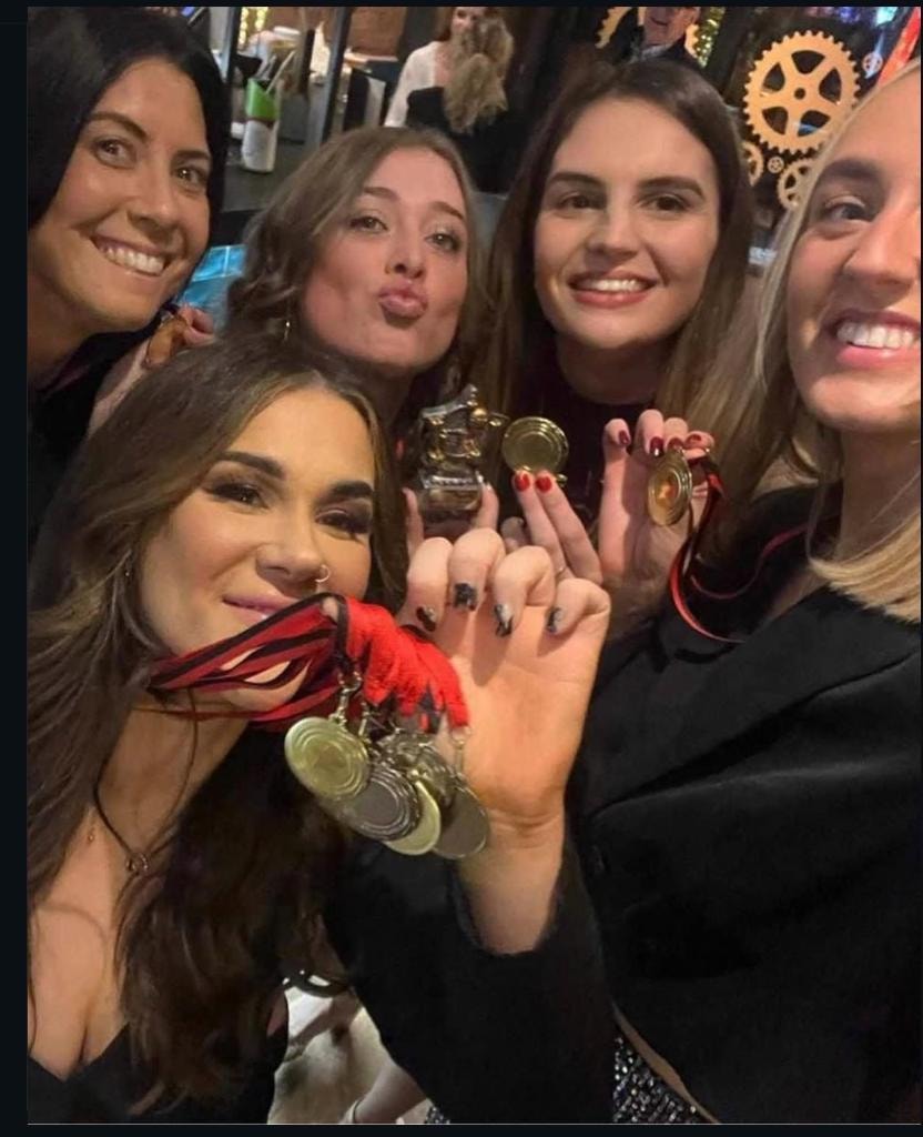Group of women celebrating with medals
